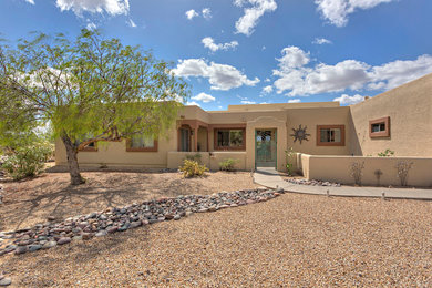 Mid-sized southwest beige one-story stucco exterior home photo in Phoenix