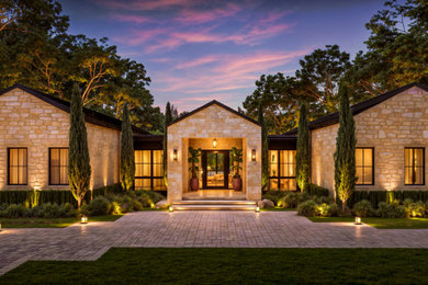Inspiration for a huge contemporary beige one-story stone exterior home remodel with a metal roof and a black roof