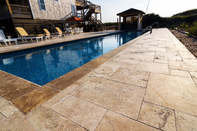 Large elegant backyard rectangular and concrete paver natural hot tub photo in Other