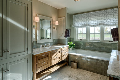 Design ideas for a mid-sized country master bathroom in Denver with a drop-in sink, shaker cabinets, granite benchtops, a drop-in tub, a two-piece toilet, green tile, glass tile, beige walls and medium wood cabinets.