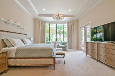 Photo of a traditional master bedroom in Orange County with beige walls, carpet and beige floor.