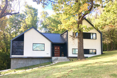 Example of a mid-sized minimalist black three-story metal exterior home design in Other with a metal roof