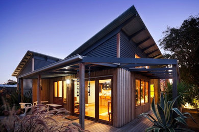 Inspiration for a mid-sized contemporary side yard patio in Melbourne with decking and a pergola.