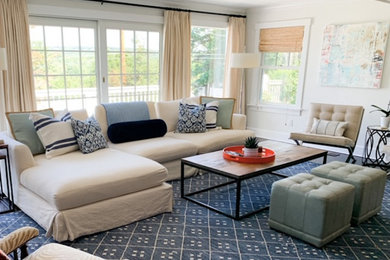 Mid-sized eclectic open concept medium tone wood floor and brown floor family room photo in New York with white walls, no fireplace and a concealed tv