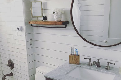Mid-sized beach style 3/4 white tile and subway tile bathroom photo in Miami with shaker cabinets, blue cabinets, a one-piece toilet, white walls, an undermount sink, granite countertops and gray countertops