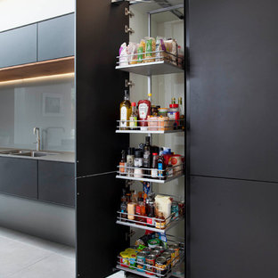 Large modern kitchen pantry remodeling - Example of a large minimalist kitchen pantry design in Belfast