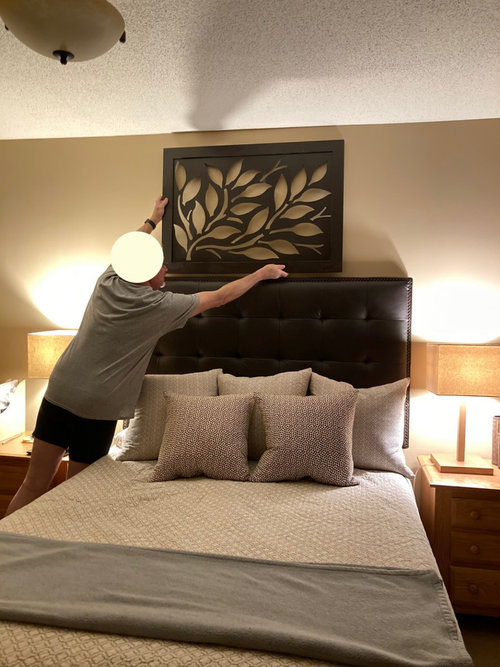 hanging wall art above headboard