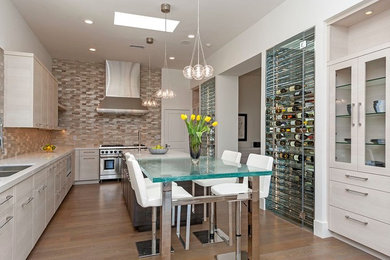 Enclosed kitchen - large modern l-shaped medium tone wood floor and brown floor enclosed kitchen idea in Los Angeles with a double-bowl sink, flat-panel cabinets, white cabinets, quartz countertops, beige backsplash, matchstick tile backsplash, stainless steel appliances and an island