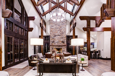 Inspiration for a large transitional open concept living room in Chicago with medium hardwood floors, a standard fireplace and a stone fireplace surround.