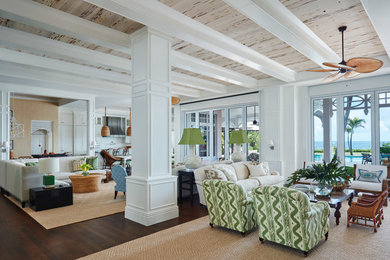 Example of a beach style brown floor living room design in Miami with white walls