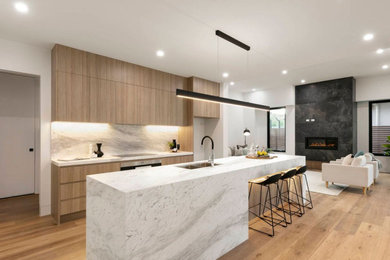 Design ideas for a large modern open plan kitchen in Melbourne with flat-panel cabinets, beige splashback, marble splashback and with island.
