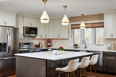 Inspiration for a large timeless l-shaped vinyl floor and brown floor eat-in kitchen remodel in Minneapolis with an undermount sink, raised-panel cabinets, medium tone wood cabinets, quartz countertops, white backsplash, ceramic backsplash, stainless steel appliances, an island and white countertops