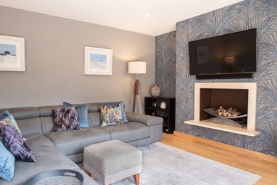 Design ideas for a large contemporary living room feature wall in Belfast with wallpapered walls.