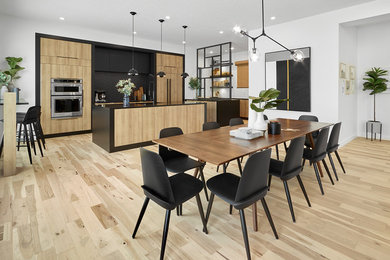 This is an example of a contemporary kitchen/dining combo in Edmonton with white walls, light hardwood floors and beige floor.