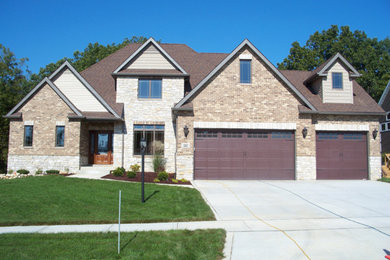 Inspiration for a mid-sized timeless beige two-story mixed siding house exterior remodel in Orange County with a hip roof and a shingle roof