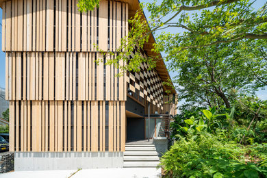 Small asian two-story wood house exterior idea in Other with a metal roof