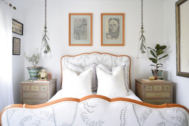 Example of a mid-sized farmhouse guest painted wood floor and green floor bedroom design in Sussex with white walls and no fireplace