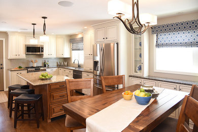 Mid-sized transitional eat-in kitchen in Boston with an undermount sink, white cabinets, quartzite benchtops, ceramic splashback, stainless steel appliances, medium hardwood floors and with island.