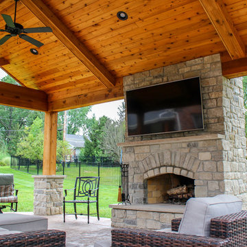 Outdoor Room with a Fireplace and Kitchen Feature