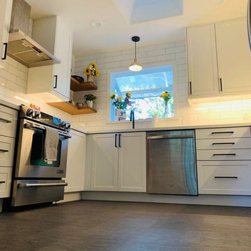 ikea white cabinets with subway tile backsplash and floating shelves