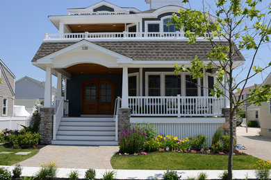 Mid-sized beach style two-storey blue exterior in Philadelphia with mixed siding.