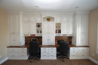 Mid-sized elegant built-in desk carpeted and beige floor study room photo in Salt Lake City with beige walls