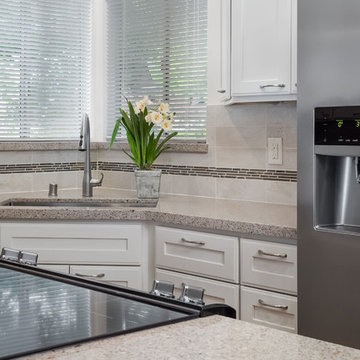 Stainless Steel Appliances and Beige Countertops in Contemporary Kitchen Remodel