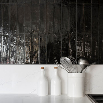 Vertical Stacked Backsplash Tile in Black and White Kitchen