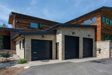 Example of a mid-sized minimalist attached three-car garage design in Salt Lake City