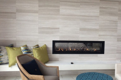 Photo of a modern master bedroom in Portland with a two-sided fireplace.