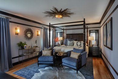 Photo of a large transitional master bedroom in Chicago with blue walls.