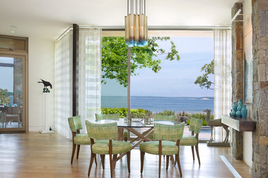 Dining room - contemporary light wood floor dining room idea in New York with white walls