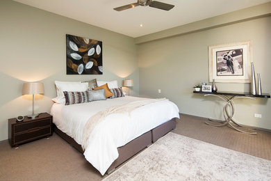 This is an example of a small modern master bedroom in Gold Coast - Tweed with beige walls and carpet.