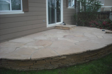 Design ideas for a mid-sized southwestern partial sun backyard stone landscaping in Denver.