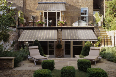Design ideas for a modern patio in Other with an awning.