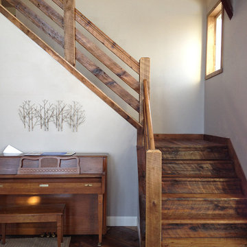 Reclaimed Wood Stair Treads, Railing, and Flooring in Rustic Entryway