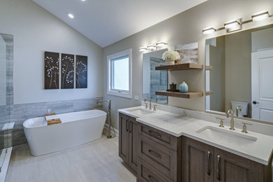 Example of a large transitional master wood-look tile floor, gray floor and double-sink bathroom design in Chicago with recessed-panel cabinets, gray cabinets, an undermount sink, quartz countertops, gray countertops, a niche and a freestanding vanity