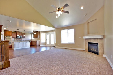 This is an example of a large arts and crafts open concept family room in Salt Lake City with beige walls, carpet, a corner fireplace, a tile fireplace surround and a built-in media wall.