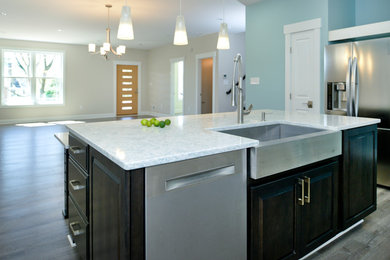Inspiration for a mid-sized timeless u-shaped dark wood floor open concept kitchen remodel in DC Metro with a farmhouse sink, granite countertops, multicolored backsplash, glass tile backsplash, stainless steel appliances, raised-panel cabinets, white cabinets and an island