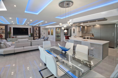 Inspiration for a large contemporary porcelain tile, gray floor and tray ceiling great room remodel in Miami with gray walls