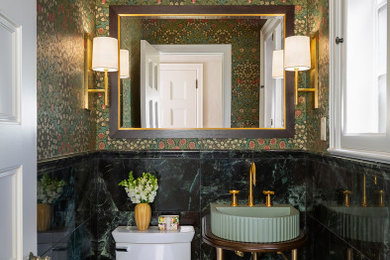 Example of a small green tile and marble tile marble floor, green floor, wallpaper ceiling and wallpaper powder room design in Minneapolis with green cabinets, a two-piece toilet, green walls, a console sink, concrete countertops, green countertops and a floating vanity