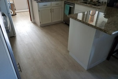 Photo of a modern kitchen in Sacramento with vinyl floors.