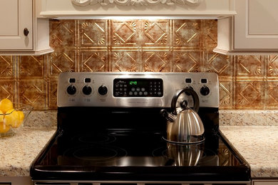 Kitchen - traditional kitchen idea in Other with metallic backsplash