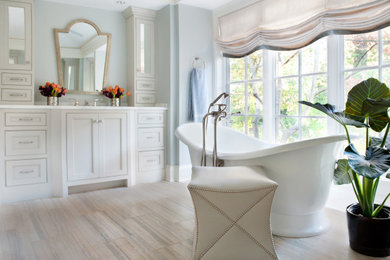 Transitional master porcelain tile, multicolored floor, single-sink and tray ceiling freestanding bathtub photo in Chicago with beaded inset cabinets, beige cabinets, blue walls, an integrated sink, quartzite countertops, white countertops and a built-in vanity