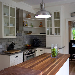 Mid-sized transitional kitchen pantry designs - Inspiration for a mid-sized transitional u-shaped light wood floor kitchen pantry remodel in Montreal with a drop-in sink, shaker cabinets, white cabinets, wood countertops, gray backsplash, cement tile backsplash, stainless steel appliances and an island