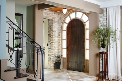 Mid-sized ceramic tile entryway photo in Grand Rapids with beige walls and a dark wood front door