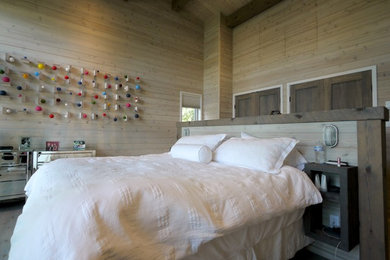 Example of a mid-sized trendy guest bedroom design in Other with beige walls and no fireplace