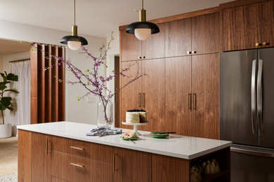 Large mid-century modern terrazzo floor and multicolored floor kitchen photo in Minneapolis with an undermount sink, flat-panel cabinets, medium tone wood cabinets, quartz countertops, white backsplash, ceramic backsplash, stainless steel appliances, an island and white countertops