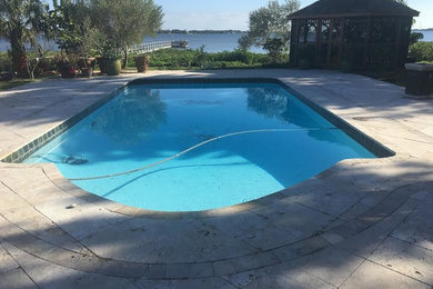 Mid-sized island style backyard concrete paver and rectangular lap pool photo in San Diego