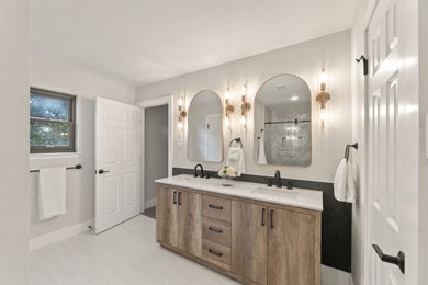 Mid-sized trendy master black tile and mosaic tile double-sink, ceramic tile and gray floor bathroom photo in Austin with flat-panel cabinets, medium tone wood cabinets, quartz countertops, white countertops, a freestanding vanity, white walls and an undermount sink